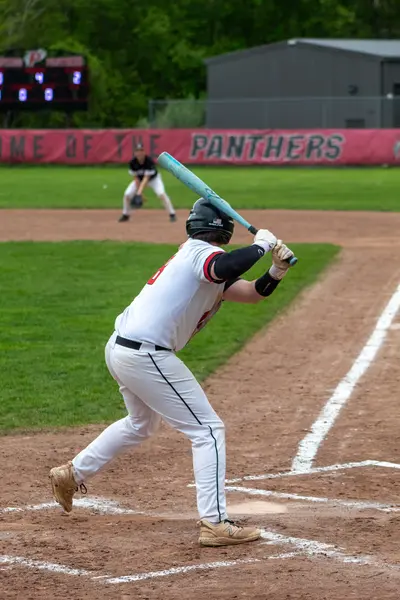 Pomperaug batter following through on a swing at home plate