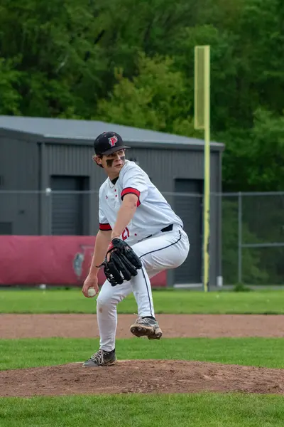 Pomperaug pitcher mid windup on the mound
