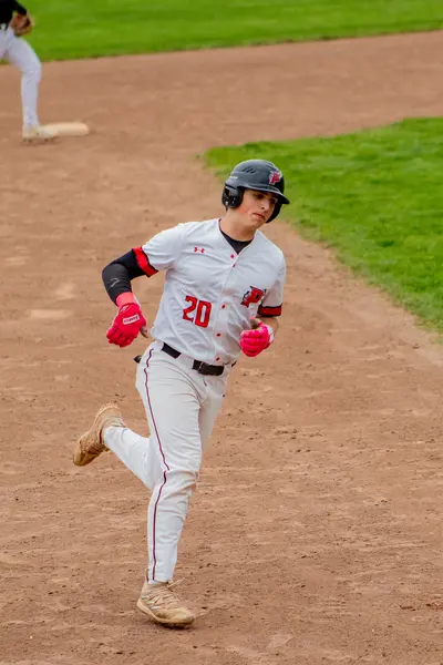 Pomperaug baserunner rounding the bases after a hit