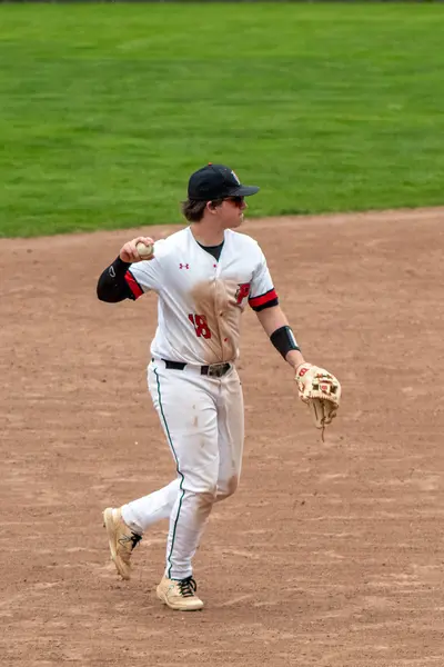 Infielder throwing to first base after fielding a grounder