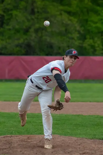 Pomperaug pitcher releasing the ball toward home plate