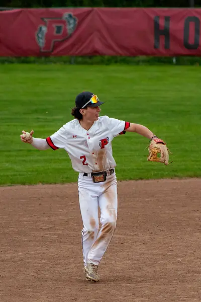 Infielder throwing across the diamond to first base