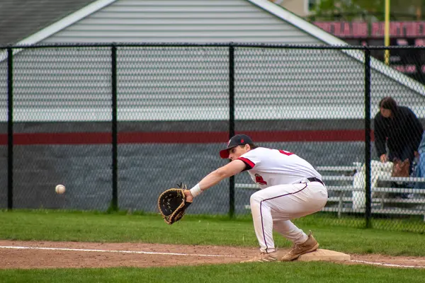 First baseman stretching to receive a throw