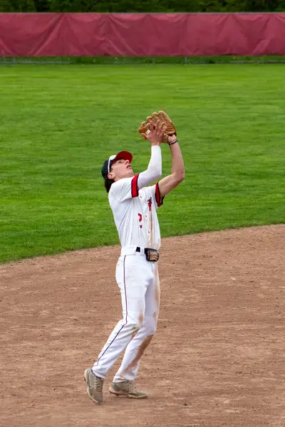 Outfielder settling under a fly ball for the catch