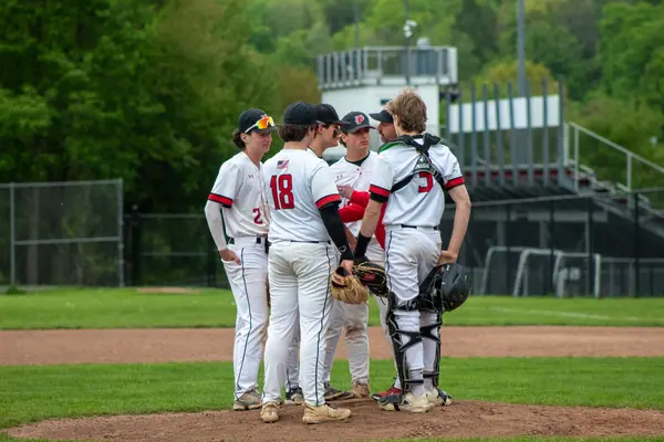 Team meeting on the mound with the coach and catcher