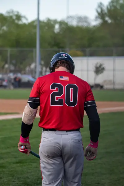 Batter walking back to the dugout, bat in hand