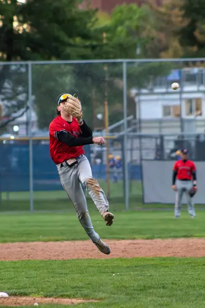 Infielder leaping to make a throw across the diamond
