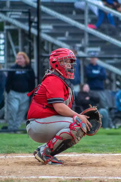 Catcher crouched behind the plate ready for the pitch