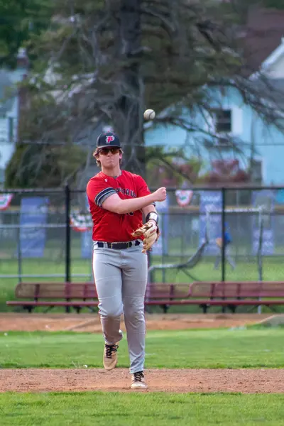 Infielder jogging back to position, ball in hand