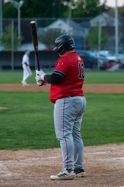 Batter waiting on a pitch, bat held high