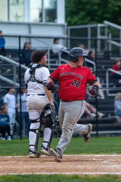 Runner jogging toward home plate after scoring