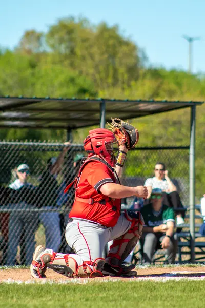 Catcher popping up after receiving a pitch