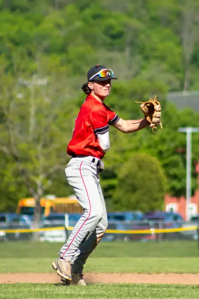 Infielder tracking a ball, glove ready