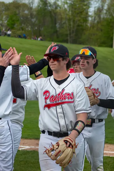 Teammates high-fiving down the line after a win