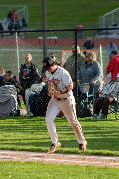 Infielder jogging back to the dugout with the glove tucked
