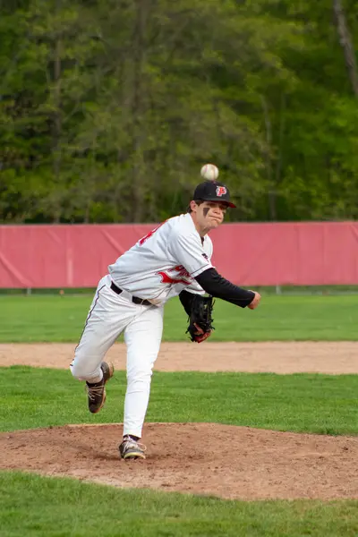 Pitcher following through on his delivery, ball just released