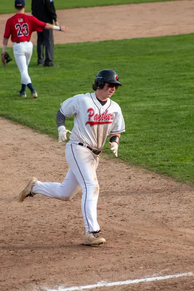 Runner rounding the bases after scoring