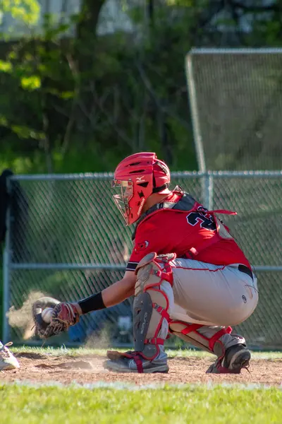 Catcher fielding a low pitch in the dirt