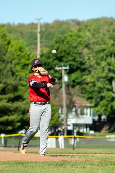 Infielder throwing across the diamond