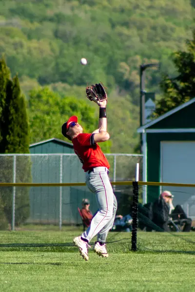 Outfielder leaping to catch a fly ball