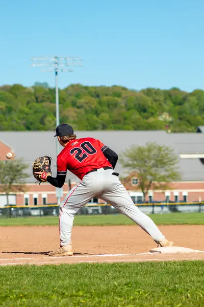 Infielder throwing to first base from the bag