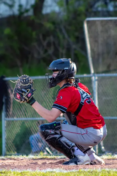 Catcher squatting behind the plate ready for the pitch