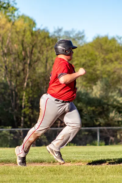 Runner rounding third and heading for home
