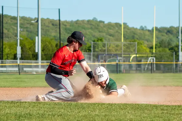 Infielder applying the tag as a runner slides in
