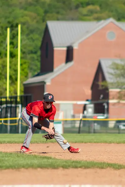 Infielder fielding a ground ball