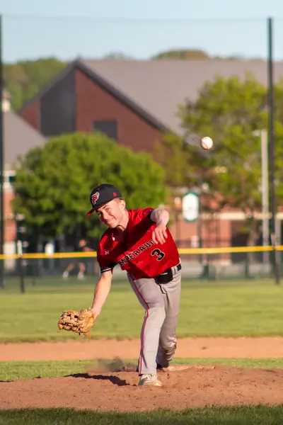 Pitcher releasing the ball toward home plate