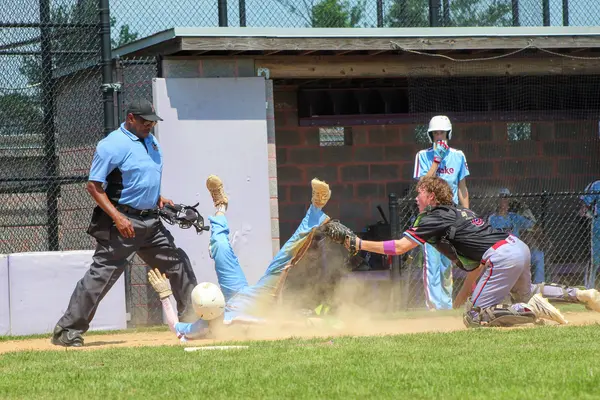Catcher scrambling to apply the tag at home plate