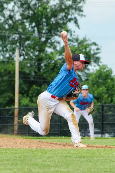 Pitcher releasing the ball toward home plate