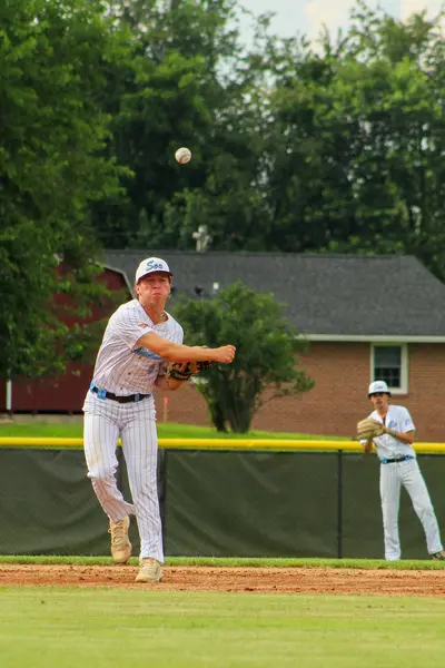 Infielder throwing across the diamond to first base