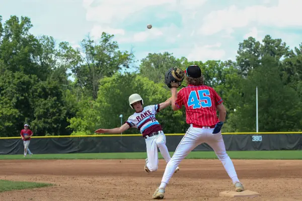 Shortstop fielding a throw as the runner steals second