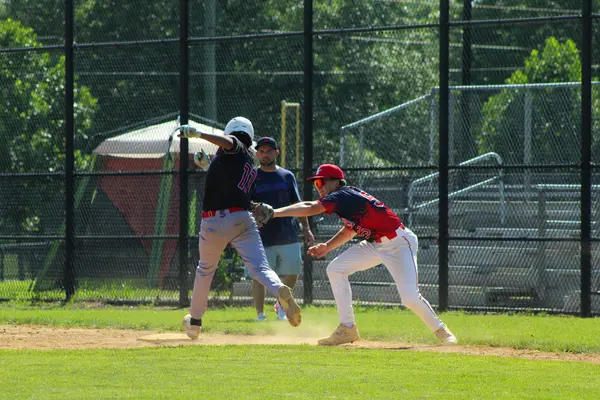Infielder applying the tag at third base