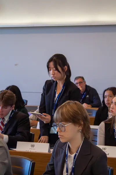 Delegate speaking while standing at her desk during committee session