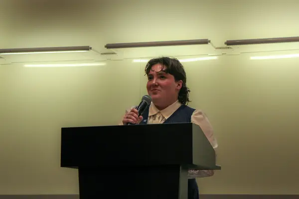 Delegate speaking into a microphone at the podium