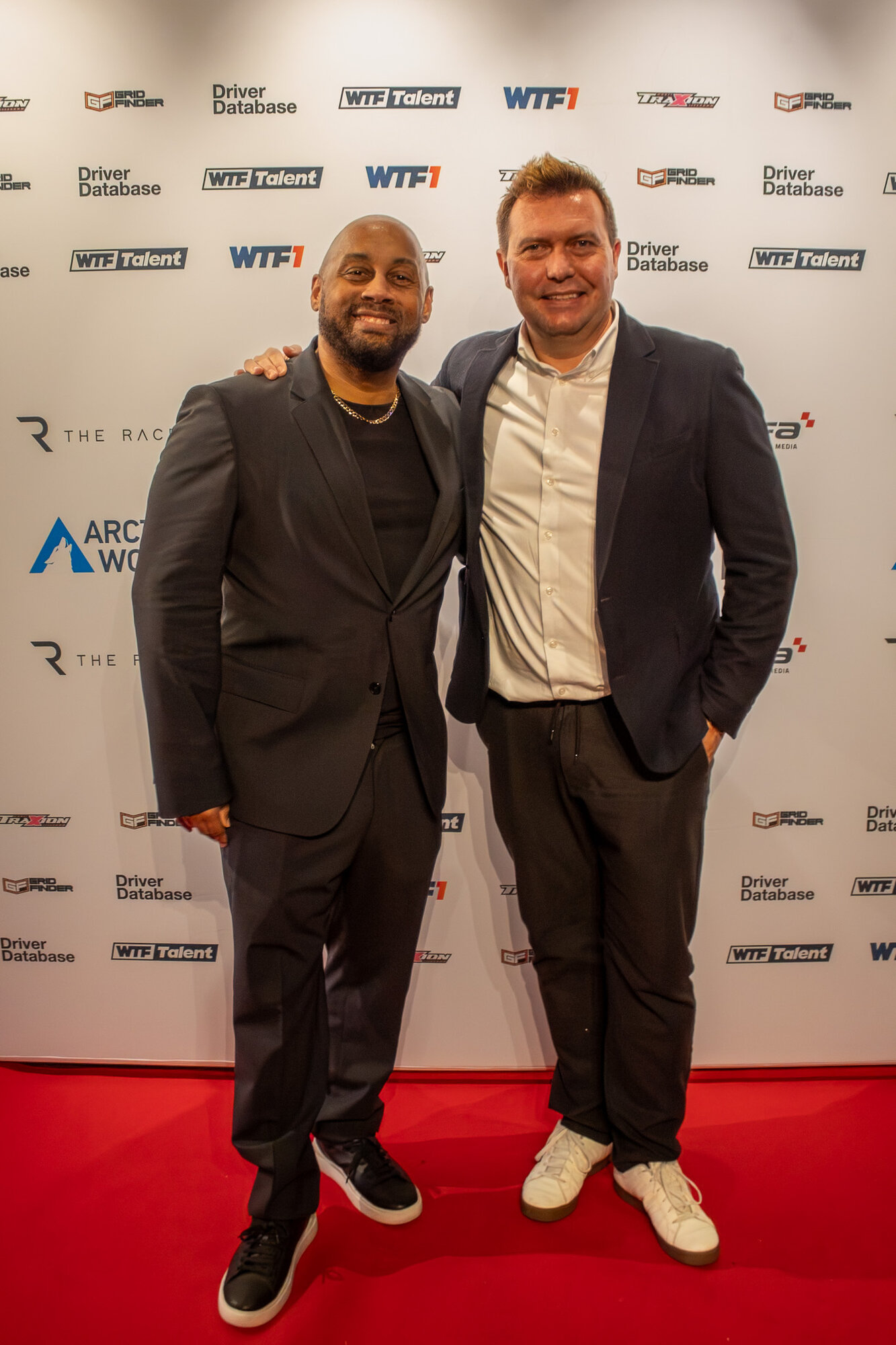Two guests posing together on the red carpet