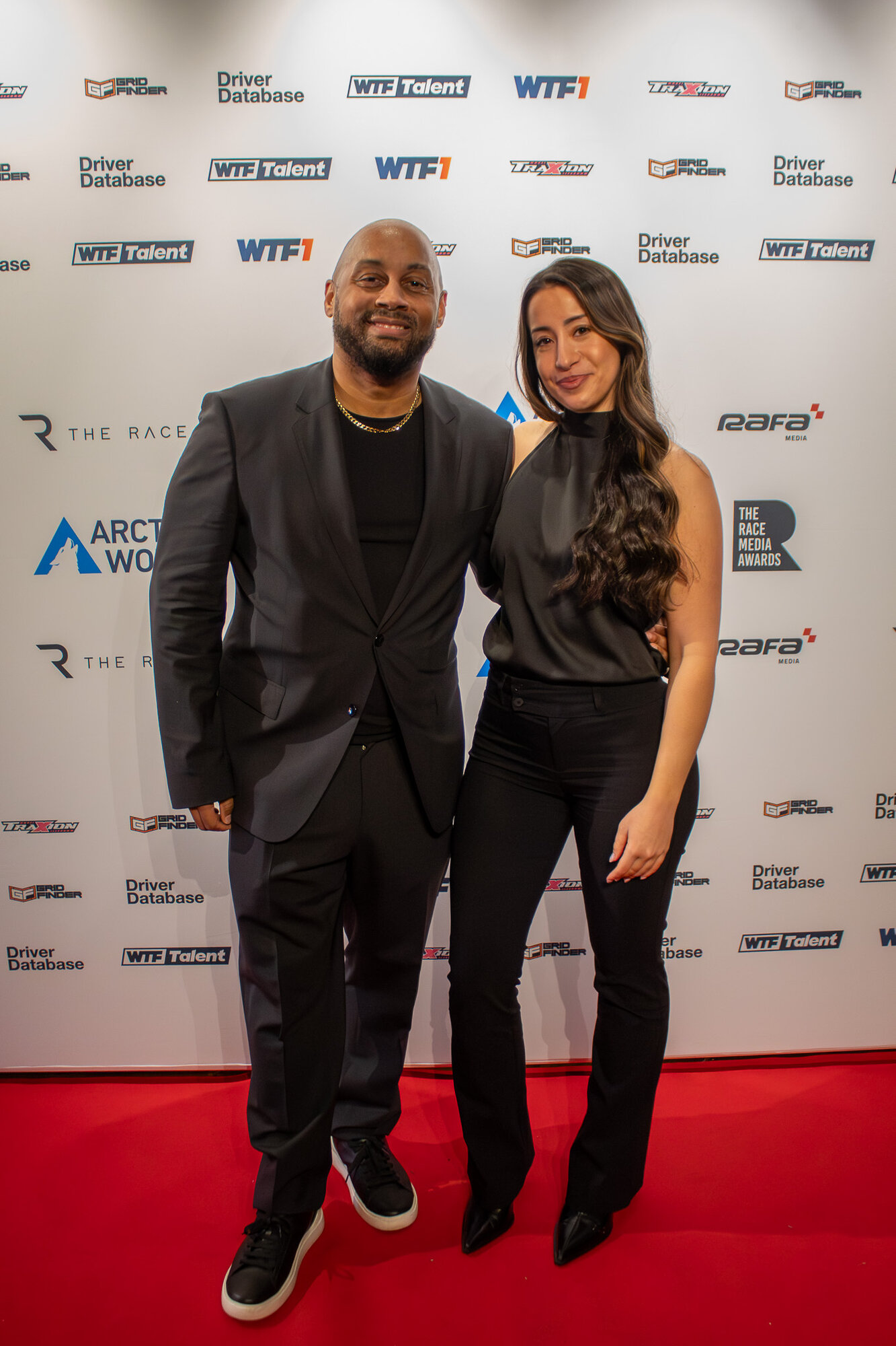 Couple posing together on the red carpet