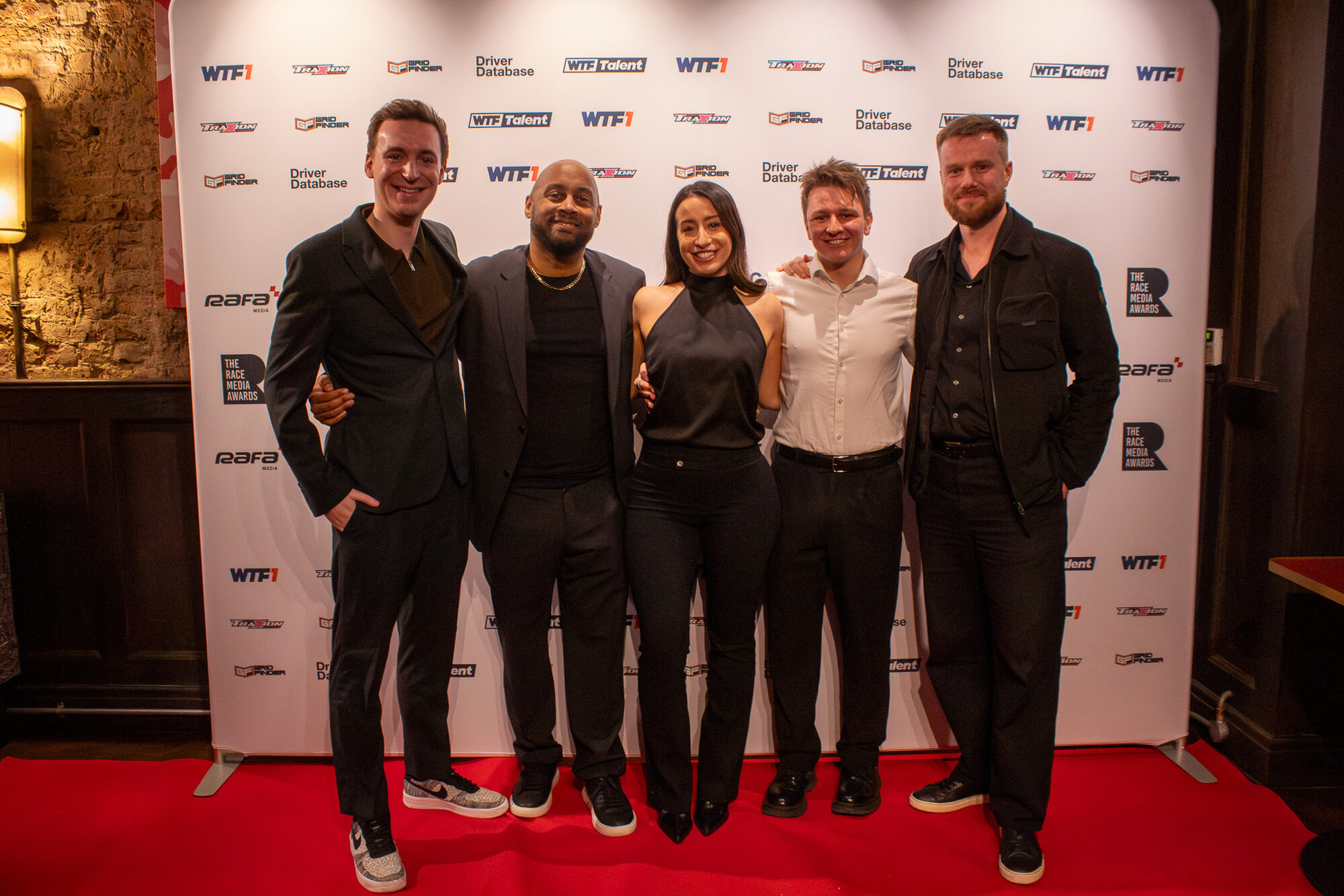 Group of five posing together on the red carpet