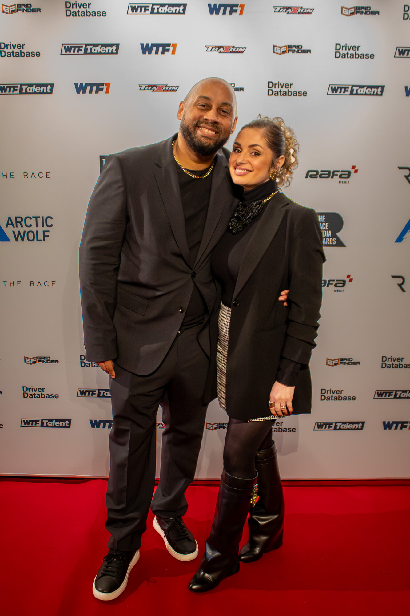 Couple smiling together on the red carpet