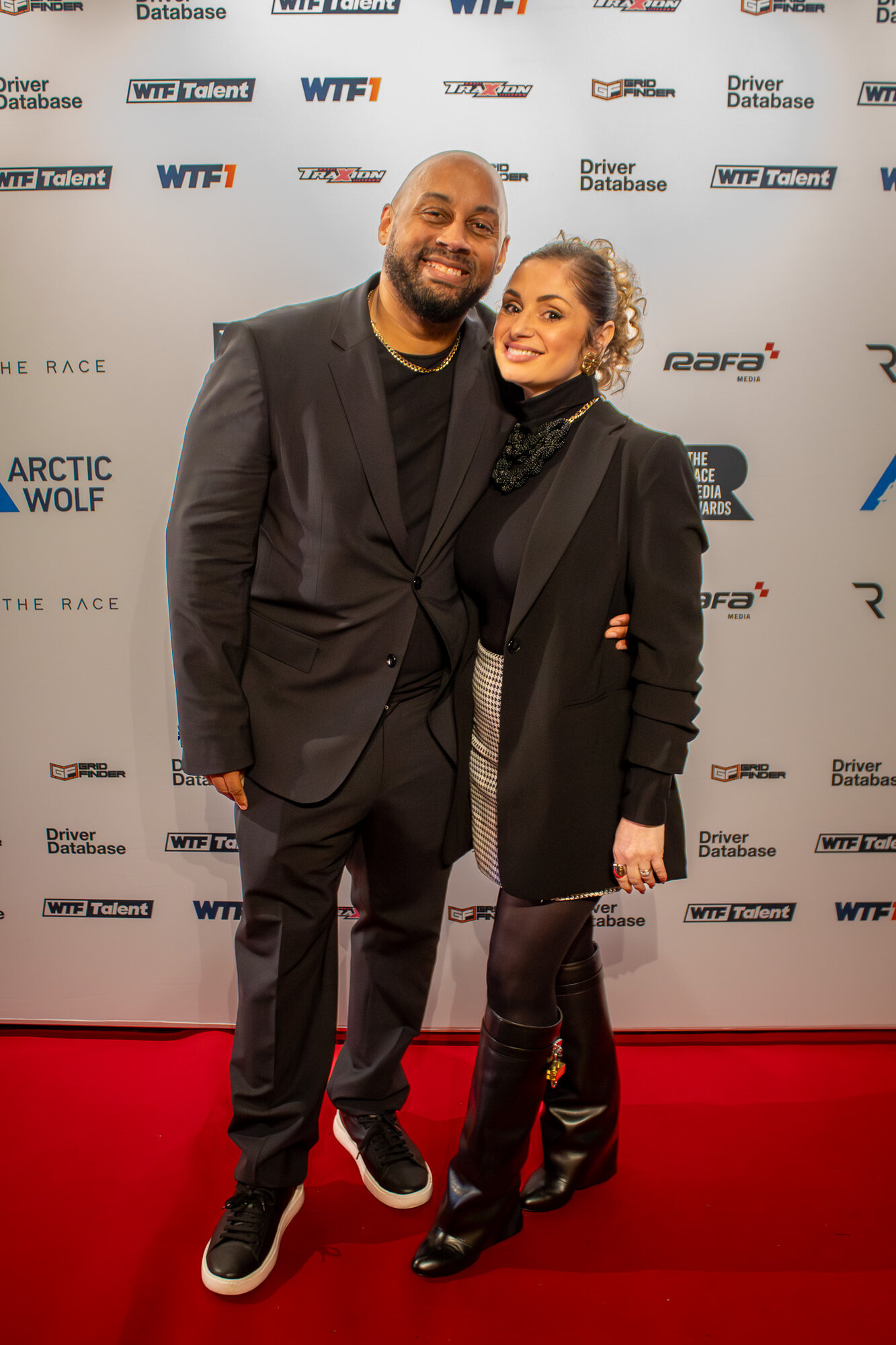 Couple posing arm in arm on the red carpet