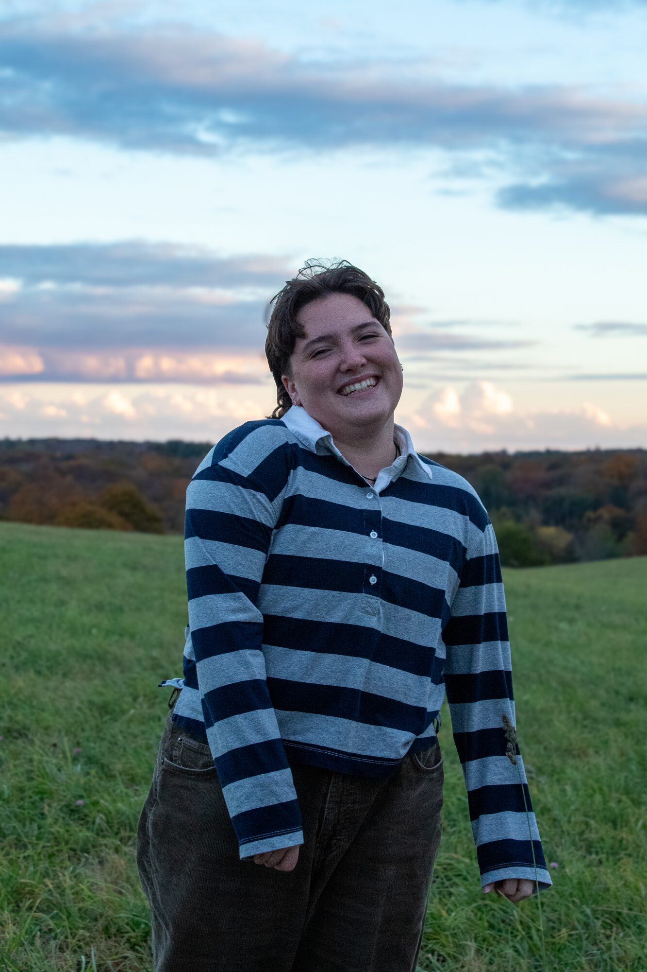 Molly senior portrait, laughing in the field at golden hour