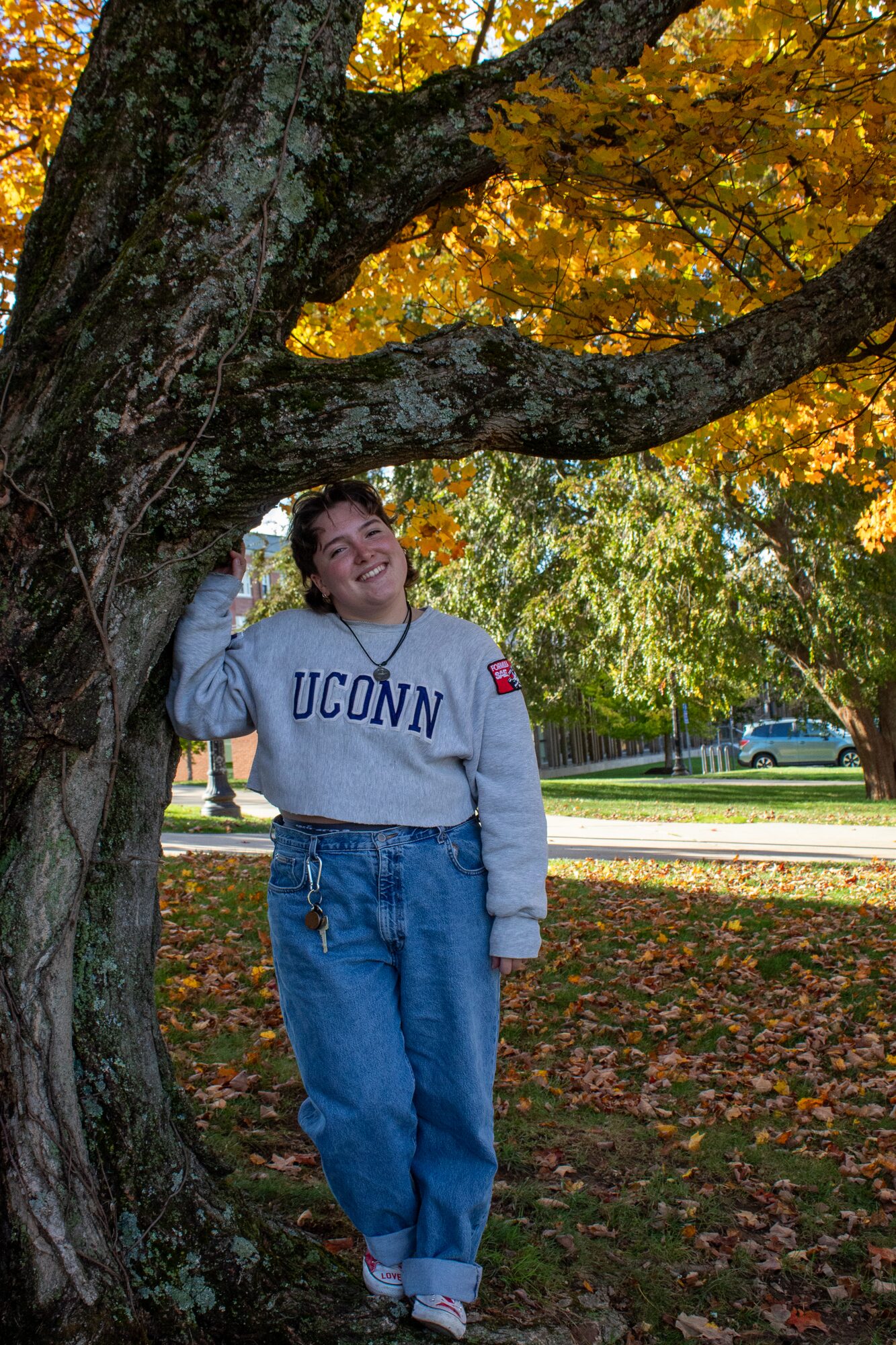 Molly senior portrait, under a golden tree on campus